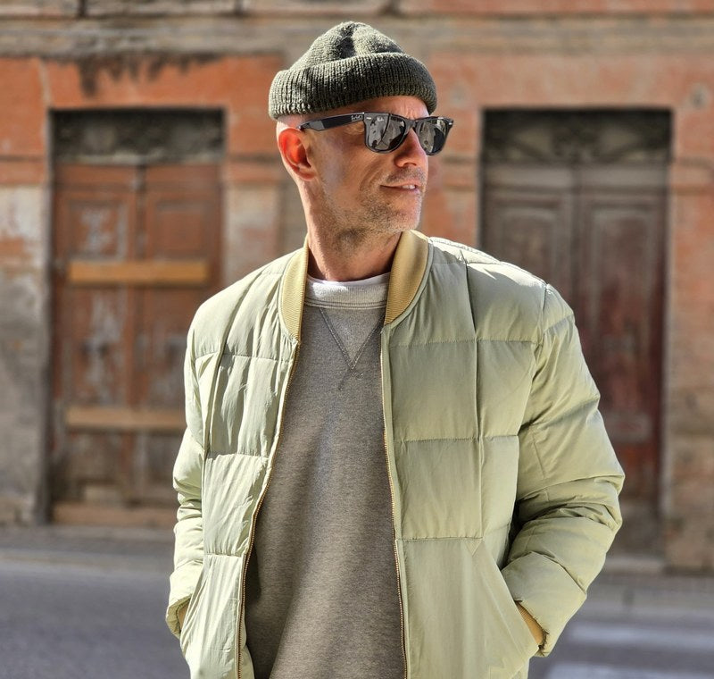 Uomo in strada con parka Chesapeake's in cotone cerato e berretto blu; accanto, uomo con caban Chesapeake's e berretto arancione.